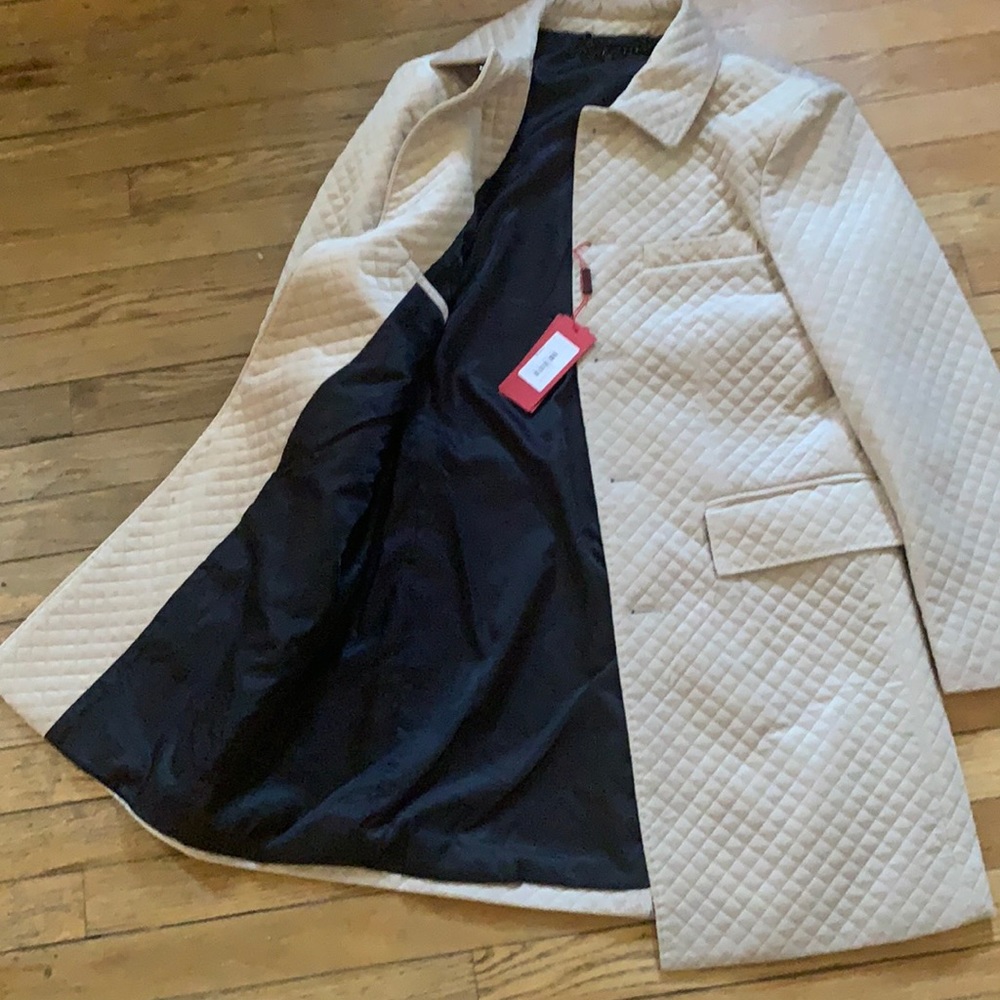 Cream pea coat. Milano is the brand. Never been worn